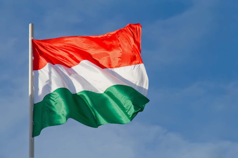 Hungary flag is waving in front of blue sky