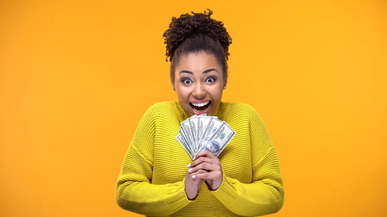 excited woman holding money