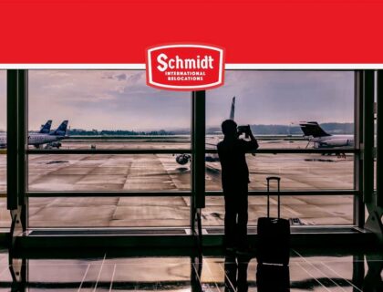 Man on airport Schmidt International Relocations logo