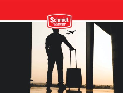 a person on the airport Schmidt International Relocations Logo