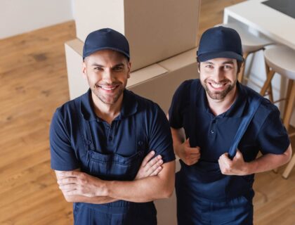 Two movers standing in front of boxes