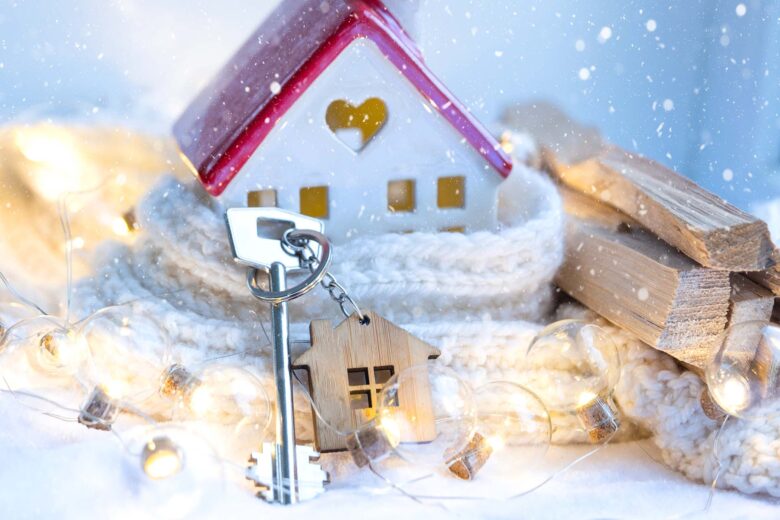Key to the house with a keychain on a cozy home with a Christmas decor