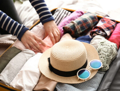 A person preparing summer clothing for moving abroad