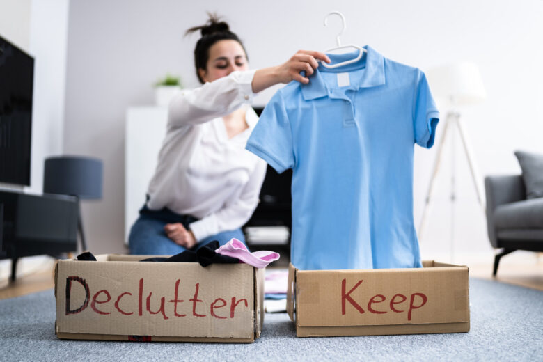 A woman decluttering her clothes before moving overseas