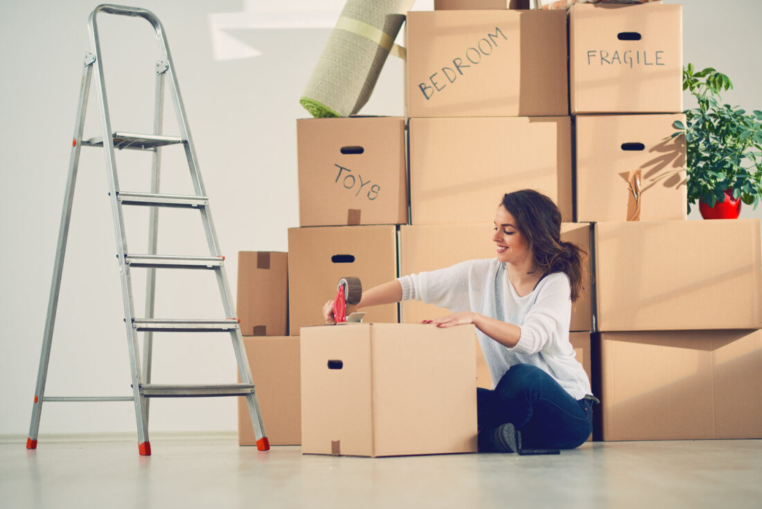 A woman packing and labeling boxes