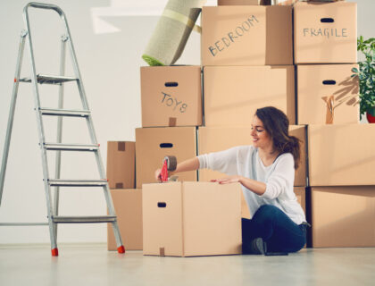 A woman packing and labeling boxes