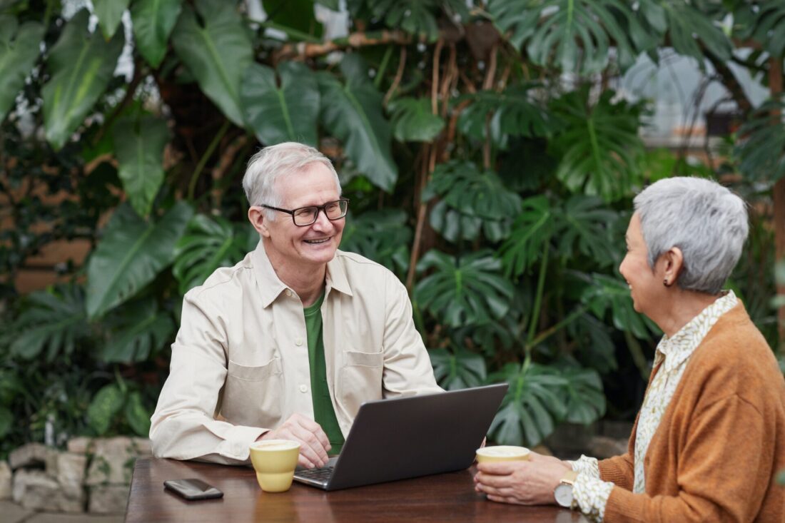 An older couple smiling and looking at each other