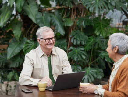 An older couple smiling and looking at each other