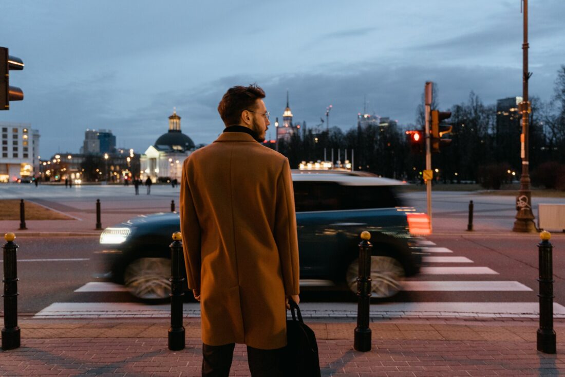 A man wearing a coat on the street