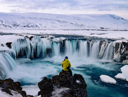 Adventurous man at Godafoss, Iceland, in winter