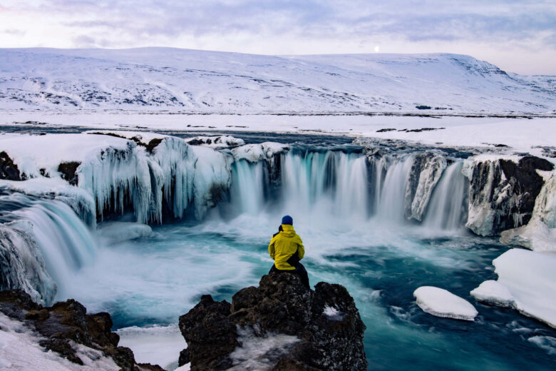 Adventurous man at Godafoss, Iceland, in winter