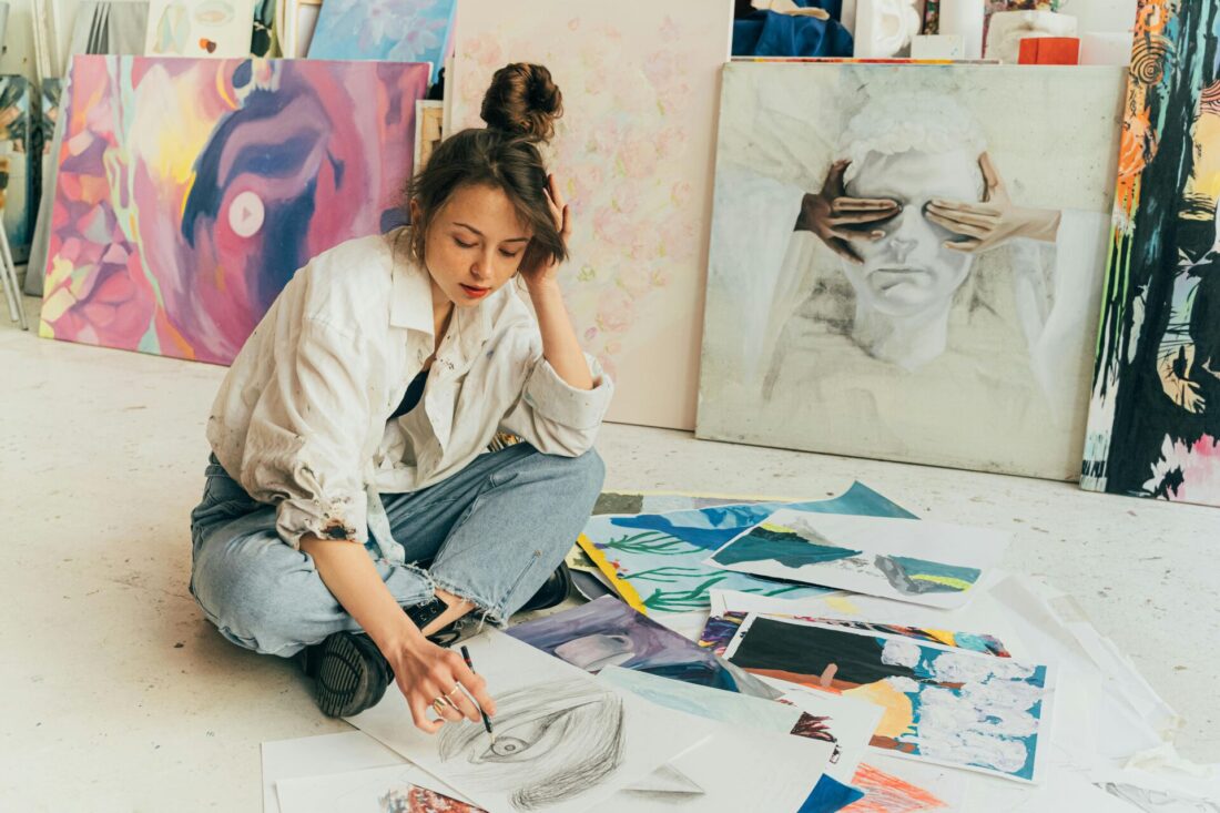 Artist sitting on the floor and painting