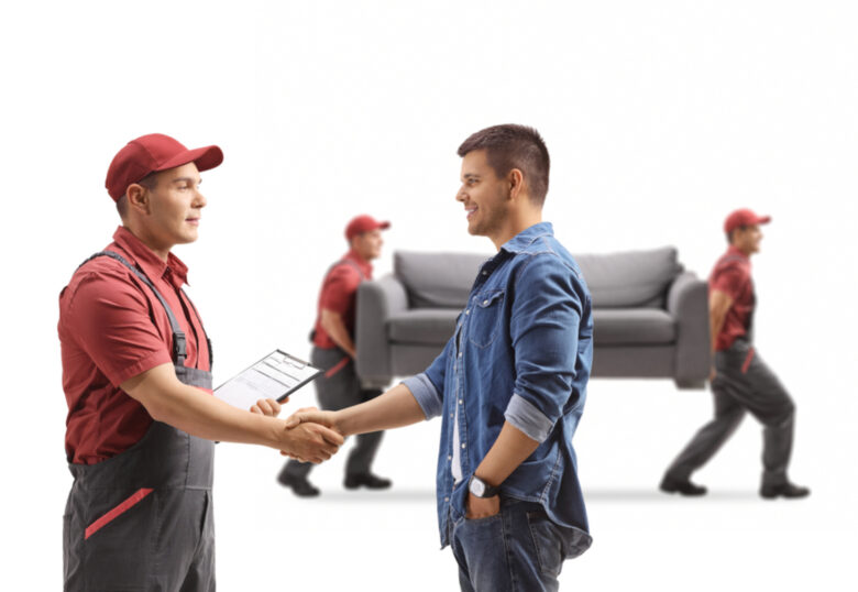 A man and a mover shaking hands, two movers in the background