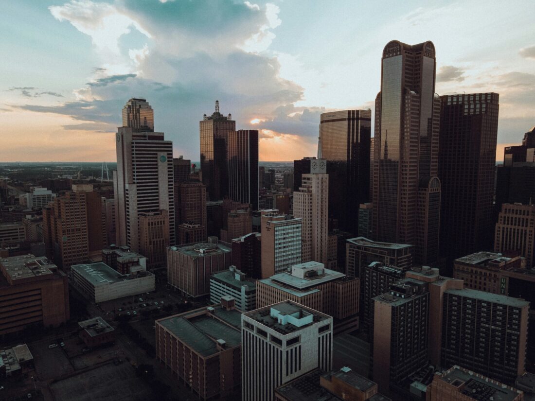 Aerial sunset view of downtown Dallas with illuminated skyscrapers and vibrant city skyline, TexasTX
